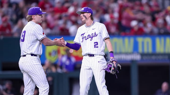Preston Gamster and Tommy LaPour hi-five after the Frogs record another out. 