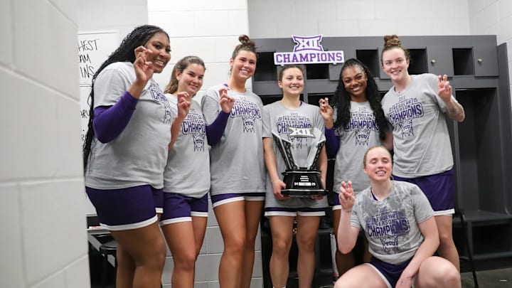 Members of the TCU women's basketball team pose with the championship trophy.