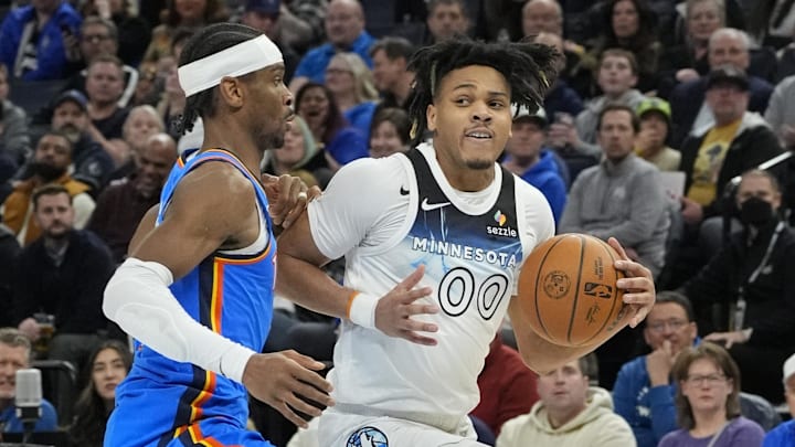 Feb 13, 2025; Minneapolis, Minnesota, USA; Minnesota Timberwolves guard Terrence Shannon Jr. (00) works past Oklahoma City Thunder guard Shai Gilgeous-Alexander (2) in the third quarter at Target Center. Mandatory Credit: Bruce Kluckhohn-Imagn Images