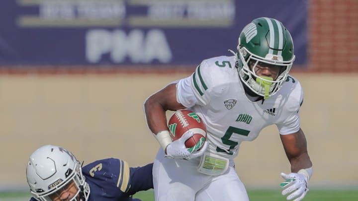University of Akron linebacker Shammond Cooper dives after OU running back Sieh Bangura on Friday,