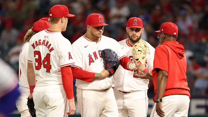 Sep 28, 2024; Anaheim, California, USA;  Los Angeles Angels relief pitcher Jose Quijada (65) is taken out of the game by manager Ron Washington (37) during the ninth inning against the Texas Rangers at Angel Stadium. Mandatory Credit: Kiyoshi Mio-Imagn Images