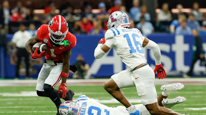 Jan 1, 2026; New Orleans, LA, USA; Georgia Bulldogs wide receiver Zachariah Branch (1) carries the ball defended by Mississippi Rebels cornerback Jaylon Braxton (2) and safety Wydett Williams Jr. (16) in the first quarter during the 2026 Sugar Bowl and quarterfinal game of the College Football Playoff at Caesars Superdome. Mandatory Credit: Geoff Burke-Imagn Images Jan 1, 2026; New Orleans, LA, USA; Georgia Bulldogs wide receiver Zachariah Branch (1) carries the ball defended by Mississippi Rebels cornerback Jaylon Braxton (2) and safety Wydett Williams Jr. (16) in the first quarter during the 2026 Sugar Bowl and quarterfinal game of the College Football Playoff at Caesars Superdome. Mandatory Credit: Geoff Burke-Imagn Images