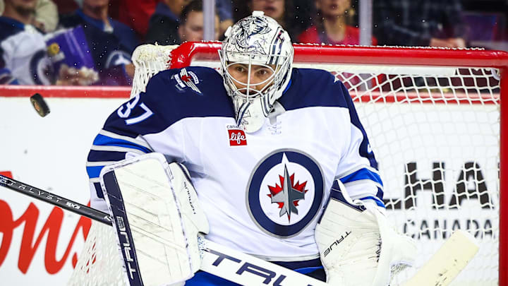 Oct 4, 2024; Calgary, Alberta, CAN; Winnipeg Jets goaltender Connor Hellebuyck (37) makes a save against the Calgary Flames during the second period at Scotiabank Saddledome. Mandatory Credit: Sergei Belski-Imagn Images