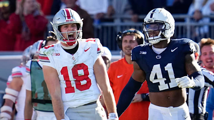 Ohio State Buckeyes quarterback Will Howard (18) celebrates a first down run beside Penn State Nittany Lions linebacker Kobe King (41) during the NCAA football game at Beaver Stadium in University Park, Pa. on Monday, Nov. 4, 2024. Ohio State won 20-13.
