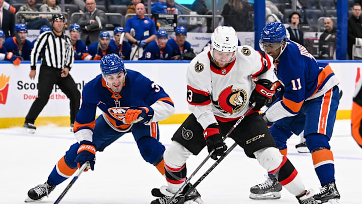 Jan 14, 2025; Elmont, New York, USA; Ottawa Senators defenseman Nikolas Matinpalo (33) skates with the puck defended by New York Islanders defenseman Adam Pelech (3) during the third period at UBS Arena. Mandatory Credit: Dennis Schneidler-Imagn Images Jan 14, 2025; Elmont, New York, USA; Ottawa Senators defenseman Nikolas Matinpalo (33) skates with the puck defended by New York Islanders defenseman Adam Pelech (3) during the third period at UBS Arena. Mandatory Credit: Dennis Schneidler-Imagn Images