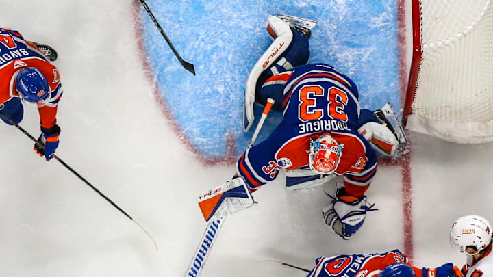 Bakersfield goaltender Olivier Rodrigue (33) reaches out to try to pull in the puck safely during