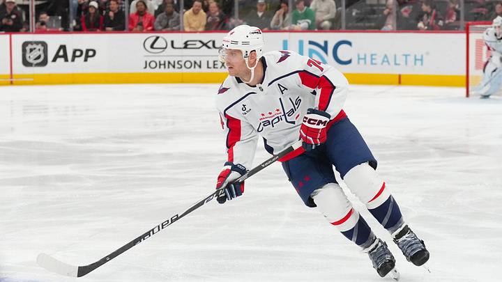 Nov 11, 2025; Raleigh, North Carolina, USA;  Washington Capitals defenseman John Carlson (74) skates with the puck against the Carolina Hurricanes during the first period at Lenovo Center. Mandatory Credit: James Guillory-Imagn Images