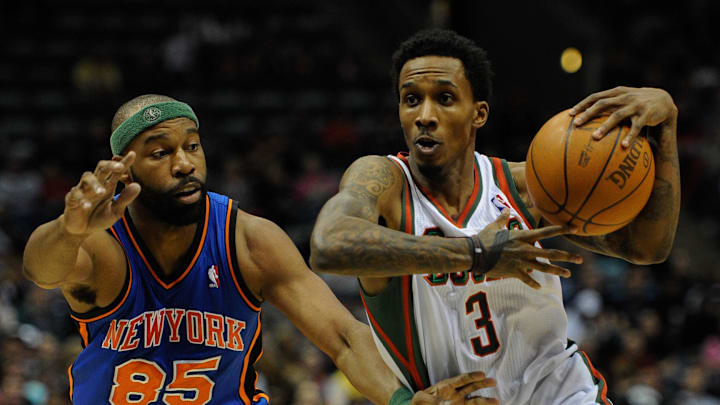 Milwaukee Bucks guard Brandon Jennings drives past New York Knicks guard Baron Davis.