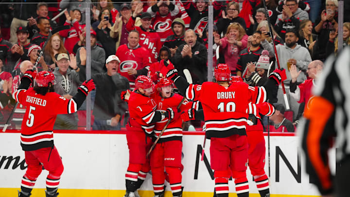 Oct 15, 2024; Raleigh, North Carolina, USA;  Carolina Hurricanes right wing Jackson Blake (53) celebrates his goal with Carolina Hurricanes defenseman Dmitry Orlov (7) against the New Jersey Devils during the third period at PNC Arena. Mandatory Credit: James Guillory-Imagn Images