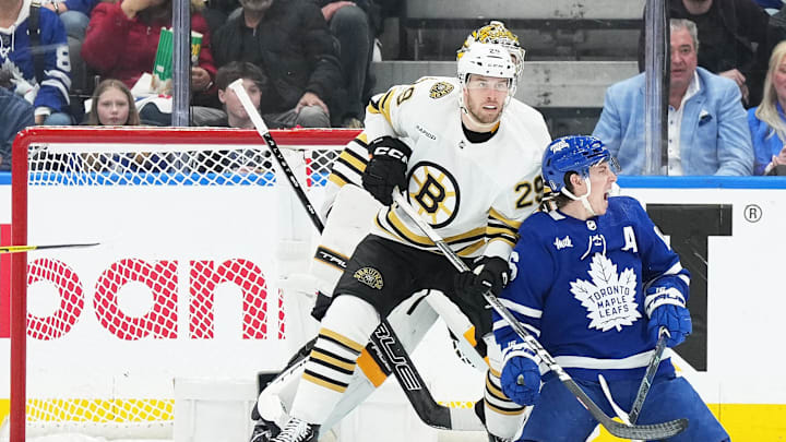 Apr 27, 2024; Toronto, Ontario, CAN; Toronto Maple Leafs right wing Mitch Marner (16) battles in front of the net with Boston Bruins defenseman Parker Wotherspoon (29) during the second period in game four of the first round of the 2024 Stanley Cup Playoffs at Scotiabank Arena. Mandatory Credit: Nick Turchiaro-USA TODAY 