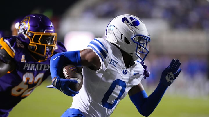 Sep 20, 2025; Greenville, North Carolina, USA;  Brigham Young Cougars cornerback Evan Johnson (0) runs with the ball after his interception against the East Carolina Pirates during the first half at Dowdy-Ficklen Stadium. Mandatory Credit: James Guillory-Imagn Images