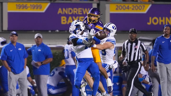 Sep 20, 2025; Greenville, North Carolina, USA;  Brigham Young Cougars cornerback Therrian Alexander III (1) and safety Tanner Wall (28) break up the pass attempt to East Carolina Pirates tight end Jayvontay Conner (8) during the first half at Dowdy-Ficklen Stadium. Mandatory Credit: James Guillory-Imagn Images