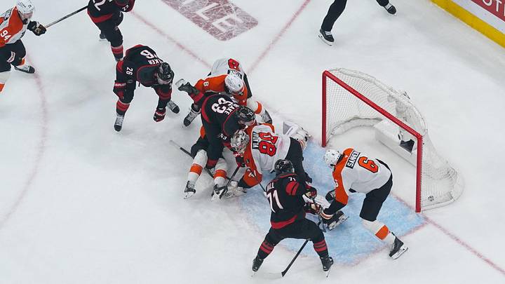 May 4, 2026; Raleigh, North Carolina, USA; Carolina Hurricanes left wing Taylor Hall (71) scores the game-winning goal past Philadelphia Flyers goaltender Dan Vladar (80) and defenseman Travis Sanheim (6) during the first overtime in game two of the second round of the 2026 Stanley Cup Playoffs at Lenovo Center.