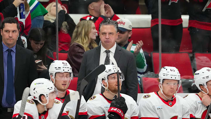 Feb 3, 2026; Raleigh, North Carolina, USA;  Ottawa Senators head coach Travis Green looks on from behind the players bench against the Carolina Hurricanes during the third period at Lenovo Center. Mandatory Credit: James Guillory-Imagn Images