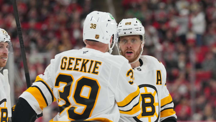 Apr 7, 2026; Raleigh, North Carolina, USA;  Boston Bruins center Morgan Geekie (39) celebrates his goal with right wing David Pastrnak (88) against the Carolina Hurricanes during the second period at Lenovo Center. Mandatory Credit: James Guillory-Imagn Images