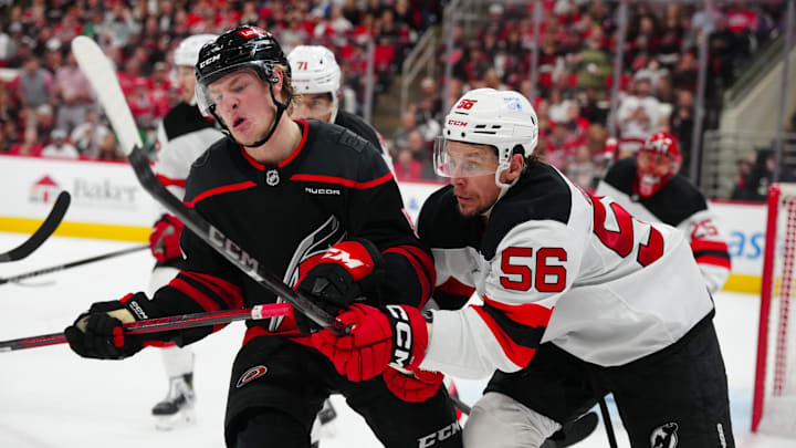 Apr 29, 2025; Raleigh, North Carolina, USA; Carolina Hurricanes right wing Jackson Blake (53) and New Jersey Devils left wing Erik Haula (56) battle during the third period in game five of the first round of the 2025 Stanley Cup Playoffs at Lenovo Center. Mandatory Credit: James Guillory-Imagn Images