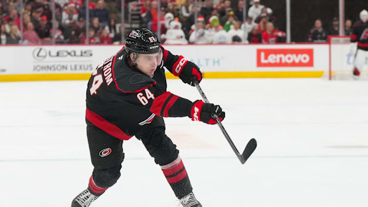 Dec 6, 2025; Raleigh, North Carolina, USA;  Carolina Hurricanes defenseman Joel Nystrom (64) takes a shot against the Nashville Predators during the first period at Lenovo Center. Mandatory Credit: James Guillory-Imagn Images
