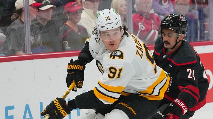 Oct 27, 2026; Raleigh, North Carolina, USA;  Boston Bruins defenseman Nikita Zadorov (91) skates with the puck against the Carolina Hurricanes during the third period at Lenovo Center.  Mandatory Credit: James Guillory-Imagn Images