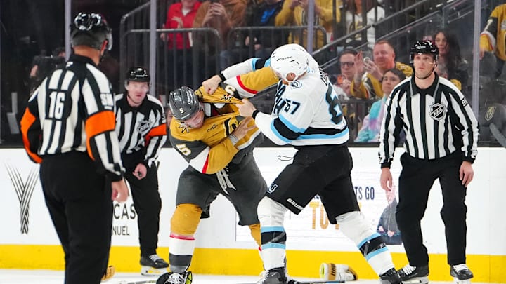 Mar 19, 2026; Las Vegas, Nevada, USA; Vegas Golden Knights defenseman Jeremy Lauzon (5) fights Utah Mammoth left wing Lawson Crouse (67) during the second period at T-Mobile Arena. Mandatory Credit: Stephen R. Sylvanie-Imagn Images