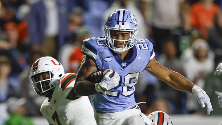Oct 14, 2023; Chapel Hill, North Carolina, USA; North Carolina Tar Heels running back Omarion Hampton (28) carries the ball against the Miami Hurricanes in the second half at Kenan Memorial Stadium. Mandatory Credit: Nell Redmond-Imagn Images