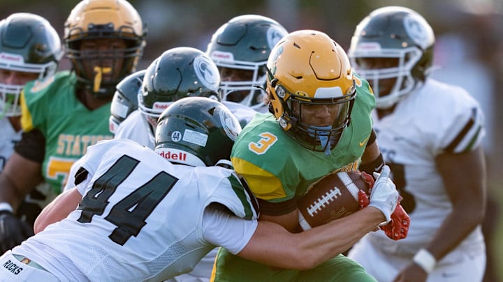 Trinity's Nick Lococo (44) tackles Bryan Station's Jordan Haskins (3) during their game on Friday, Aug. 23, 2024 at Bryan Station High School in Lexington, Ky.