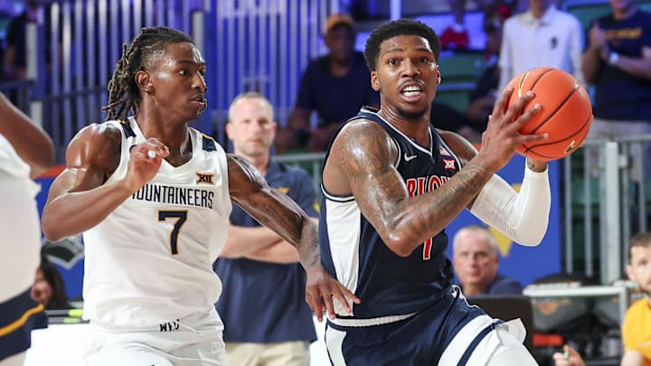 Nov 29, 2024; Paradise Island, Bahamas, BHS;  Arizona Wildcats guard Caleb Love (1) drives to the basket as West Virginia Mountaineers guard Javon Small (7) defends during the first half at Imperial Arena at the Atlantis resort.  Mandatory Credit: Kevin Jairaj-Imagn Images