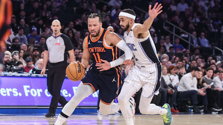 Jan 6, 2025; New York, New York, USA;  New York Knicks guard Jalen Brunson (11) drives past Orlando Magic guard Trevelin Queen (12) in the first quarter at Madison Square Garden. Mandatory Credit: Wendell Cruz-Imagn Images