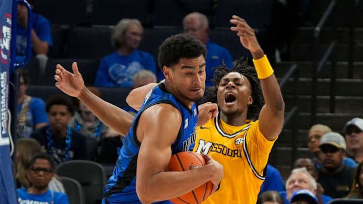 Memphis' Nicholas Jourdain (2) spins away with the ball after colliding with Missouri's Anthony Robinson II (0) during the game between the University of Memphis and Missouri at FedExForum in Memphis, Tenn., on Monday, November 4, 2024.