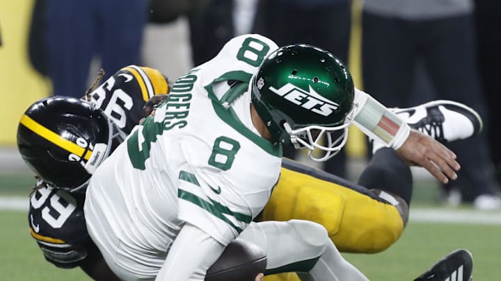 Oct 20, 2024; Pittsburgh, Pennsylvania, USA;  Pittsburgh Steelers defensive tackle Larry Ogunjobi (99) sacks New York Jets quarterback Aaron Rodgers (8) during the first quarter at Acrisure Stadium. Mandatory Credit: Charles LeClaire-Imagn Images