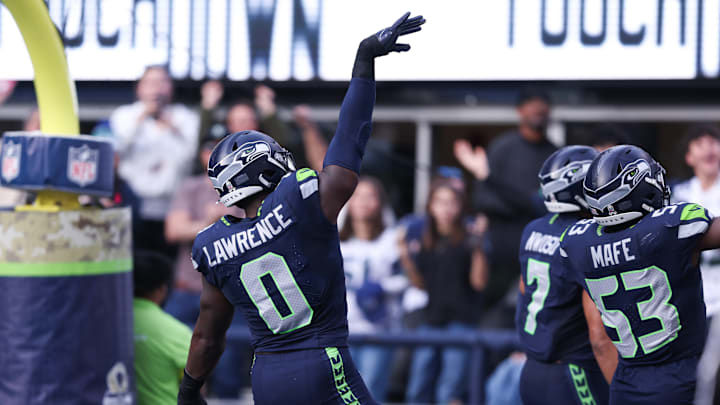 Nov 9, 2025; Seattle, Washington, USA; Seattle Seahawks defensive end DeMarcus Lawrence (0) celebrates after recovering a fumble to score a touchdown during the second quarter against the Arizona Cardinals at Lumen Field. 