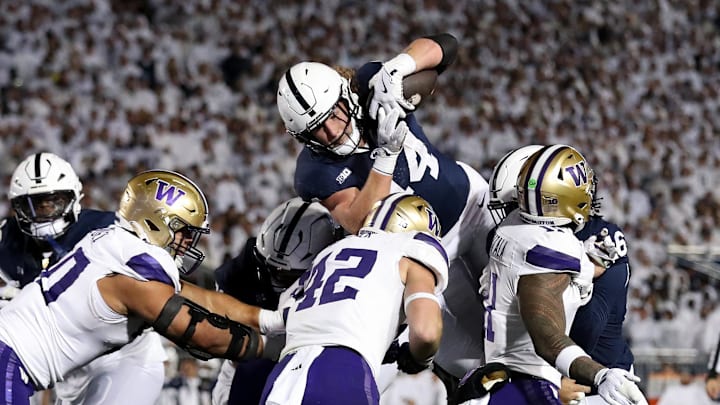 Penn State Nittany Lions tight end Tyler Warren attempts to jump over top of the Washington Huskies defense. Penn State Nittany Lions tight end Tyler Warren attempts to jump over top of the Washington Huskies defense.