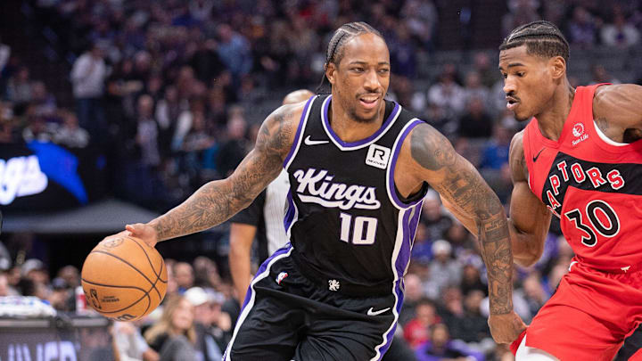Nov 6, 2024; Sacramento, California, USA; Sacramento Kings forward DeMar DeRozan (10) drives to the basket against Toronto Raptors guard Ochai Agbaji (30) during the first quarter at Golden 1 Center. Mandatory Credit: Ed Szczepanski-Imagn Images