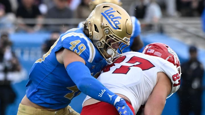 Nov 30, 2024; Pasadena, California, USA; UCLA Bruins linebacker Carson Schwesinger (49) Fresno State Bulldogs tight end Jake Tarwater (87) during the third quarter at Rose Bowl. Mandatory Credit: Robert Hanashiro-Imagn Images