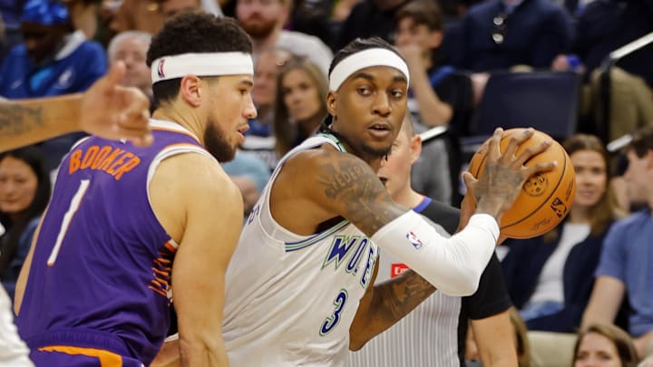 Apr 14, 2024; Minneapolis, Minnesota, USA; Minnesota Timberwolves forward Jaden McDaniels (3) works around Phoenix Suns guard Devin Booker (1) in the first quarter at Target Center. Mandatory Credit: Bruce Kluckhohn-Imagn Images Apr 14, 2024; Minneapolis, Minnesota, USA; Minnesota Timberwolves forward Jaden McDaniels (3) works around Phoenix Suns guard Devin Booker (1) in the first quarter at Target Center. Mandatory Credit: Bruce Kluckhohn-Imagn Images