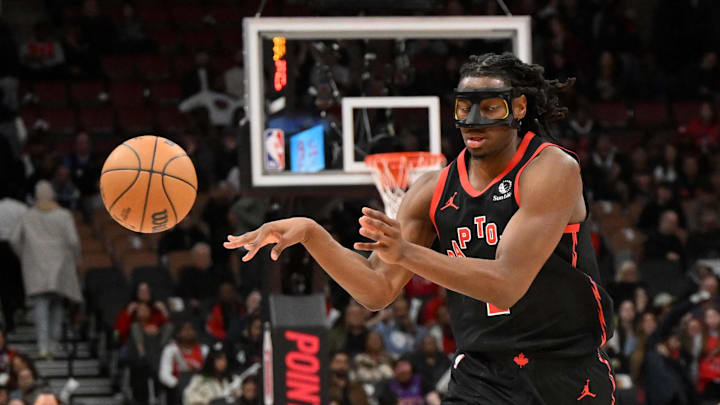 Apr 4, 2025; Toronto, Ontario, CAN;  Toronto Raptors forward Jonathan Mogbo (2) passes the ball against the Detroit Pistons in the second half at Scotiabank Arena. Mandatory Credit: Dan Hamilton-Imagn Images