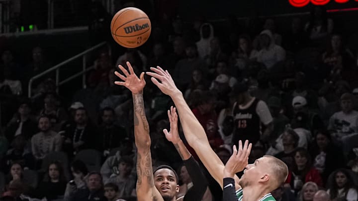 Mar 28, 2024; Atlanta, Georgia, USA; Atlanta Hawks guard Dejounte Murray (5) shoots over Boston
