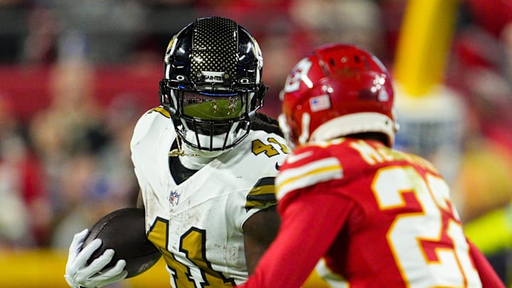 Oct 7, 2024; Kansas City, Missouri, USA; New Orleans Saints running back Alvin Kamara (41) runs the ball against Kansas City Chiefs cornerback Trent McDuffie (22) during the second half at GEHA Field at Arrowhead Stadium. Mandatory Credit: Jay Biggerstaff-Imagn Images