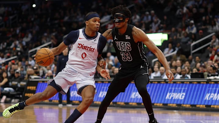 Feb 24, 2025; Washington, District of Columbia, USA; Washington Wizards guard Bilal Coulibaly (0) drives to the basket as Brooklyn Nets center Nic Claxton (33) defends in the second half at Capital One Arena. Mandatory Credit: Geoff Burke-Imagn Images