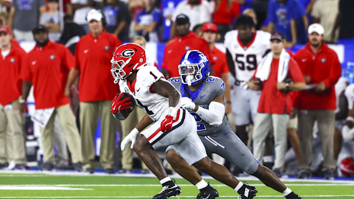 Sep 14, 2024; Lexington, Kentucky, USA; Georgia Bulldogs running back Trevor Etienne (1) runs with the ball with Kentucky Wildcats linebacker Jamon Dumas-Johnson (2) on his trail during the second half at Kroger Field. Georgia won 13-12. Mandatory Credit: Carter Skaggs-Imagn Images