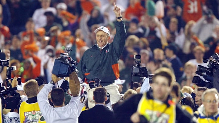 (01/03/2002)    Miami head coach Larry Coker rides on his players shoulders and holds up his finger