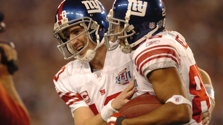 Eli Manning with celebrates David Tyree after a touchdown during Super Bowl XLII Sunday. 