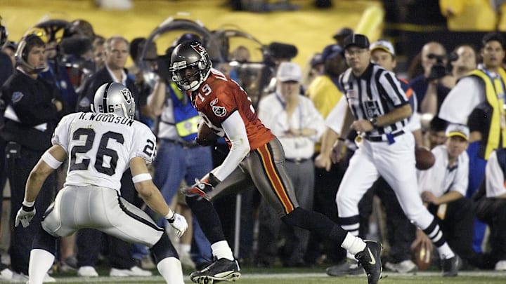 Jan 26, 2003; San Diego, CA, USA; FILE PHOTO; Tamp Bay Buccaneers receiver Keyshawn Johnson (19) carries the ball as Oakland Raiders defensive back Rod Woodson (26) closes in during Super Bowl XXXVII at Qualcomm Stadium. The Bucs defeated the Raiders 48-21. Mandatory Credit: MPS-USA TODAY Sports