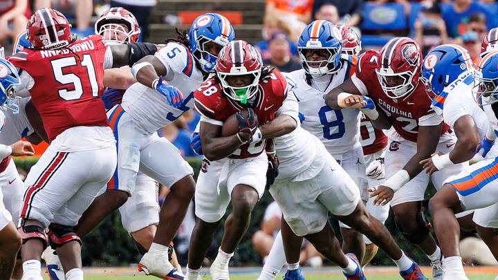 Oct 10, 2026; Gainesville, Florida, USA;  South Carolina Gamecocks running back Matt Fuller (28) rushes with the ball while Florida Gators jack Jayden Woods (0) tackles during the second half at Ben Hill Griffin Stadium.  Mandatory Credit: Matt Pendleton-Imagn Images