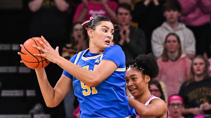 Feb 23, 2025; Iowa City, Iowa, USA; UCLA Bruins center Lauren Betts (51) is defended by Iowa Hawkeyes forward Hannah Stuelke (45) during the third quarter at Carver-Hawkeye Arena. Mandatory Credit: Jeffrey Becker-Imagn Images