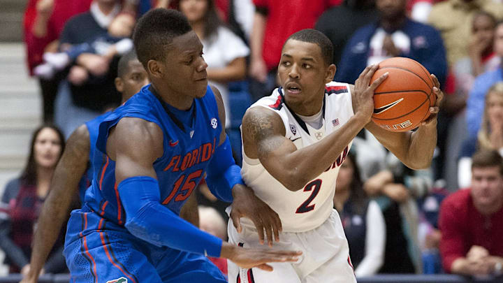 Dec 15, 2012; Tucson, AZ, USA; Arizona Wildcats guard Mark Lyons (2) prepares to pass as Florida Gators forward Will Yeguete (15) defends during the second half at McKale Center. The Wildcats beat the Gators 65-64.  Mandatory Credit: Casey Sapio-Imagn Images