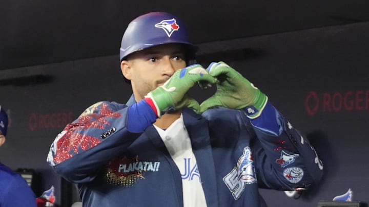 Mar 29, 2026; Toronto, Ontario, CAN; Toronto Blue Jays designated hitter George Springer (4) shows the heart symbol after his solo home run against the Athletics in the first inning at Rogers Centre. Mandatory Credit: John E. Sokolowski-Imagn Images