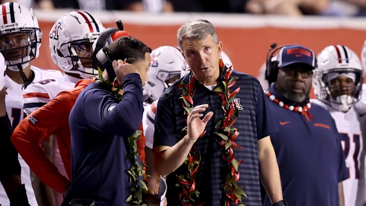 Sep 28, 2024; Salt Lake City, Utah, USA; Arizona Wildcats head coach Brent Brennan (center) during the third quarter against the Utah Utes at Rice-Eccles Stadium. Mandatory Credit: Rob Gray-Imagn Images