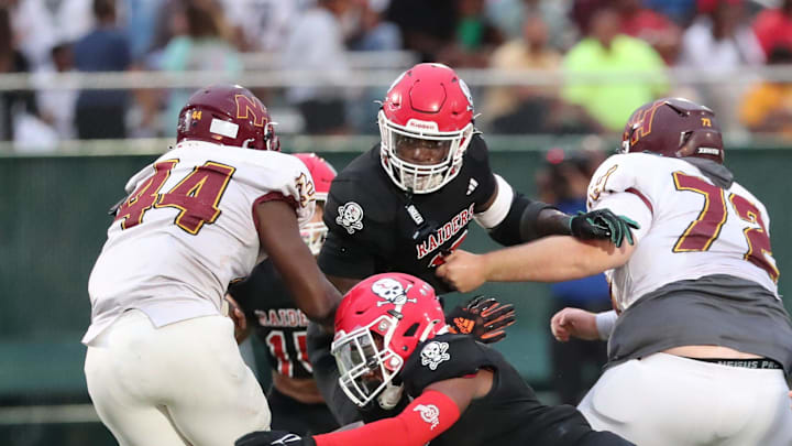 Savannah Christian's Jaden Miles and LaDamion Guyton look to stop New Hampstead's Kameron Blake-Mazes in the backfield on Friday, August 23, 2024 at Pooler Stadium.