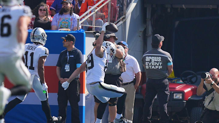Oct 6, 2024; Denver, Colorado, USA; Las Vegas Raiders tight end Brock Bowers (89) spikes the ball after his touchdown reception in the first quarter against the Denver Broncos at Empower Field at Mile High. Mandatory Credit: Ron Chenoy-Imagn Images