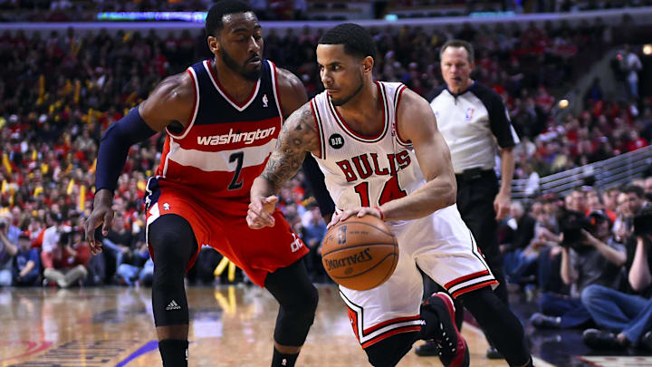 Chicago Bulls guard D.J. Augustin (14) dribbles the ball against Washington Wizards guard John Wall (2) during the 2014 NBA Playoffs at United Center. 